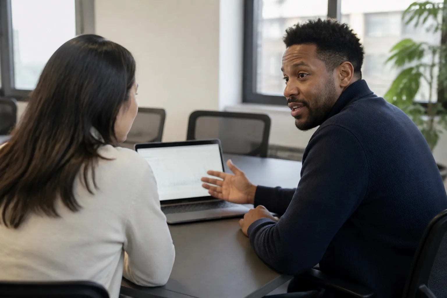 Team member in a meeting with a laptop