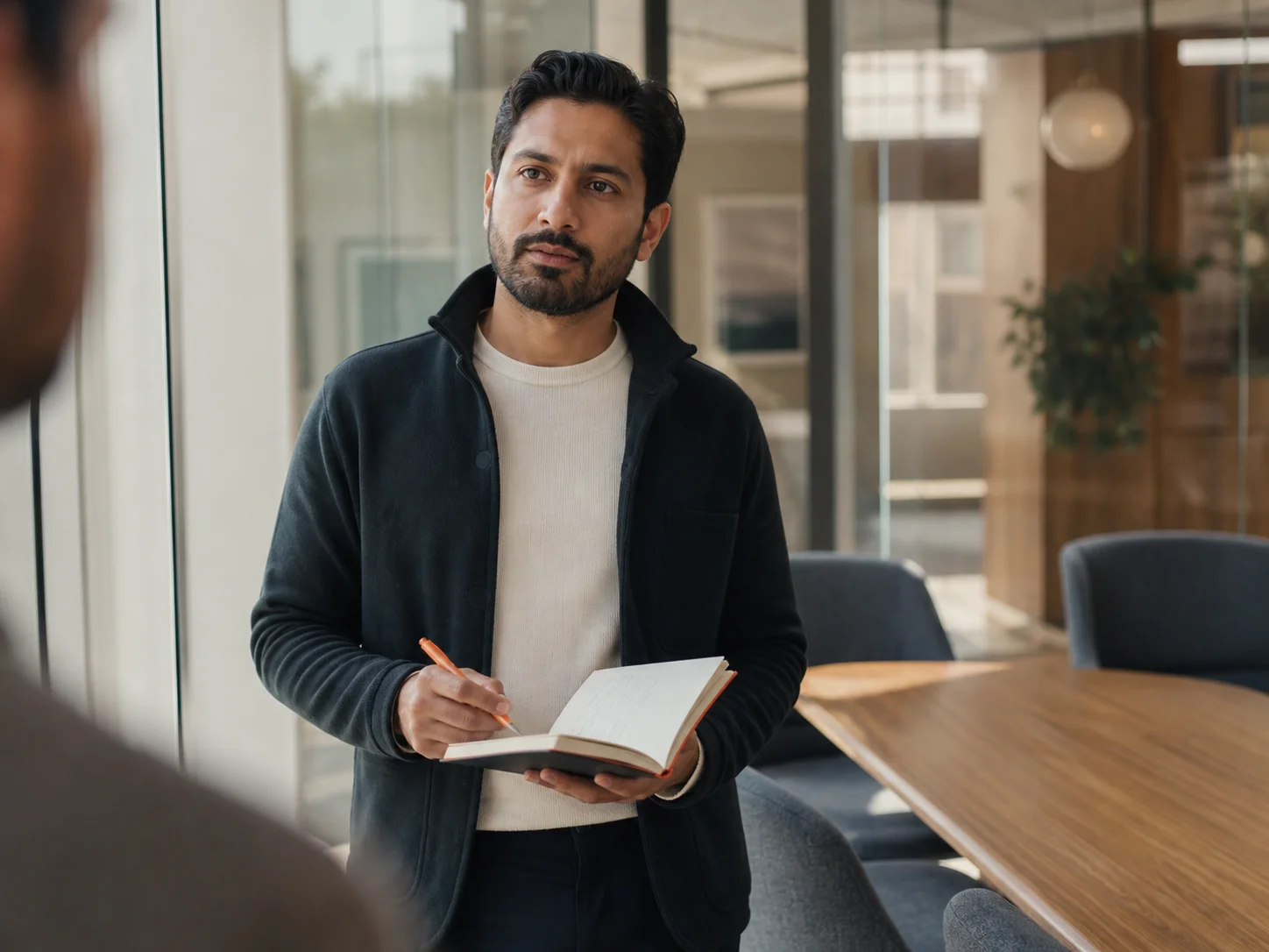 Working professional taking notes in a modern meeting room